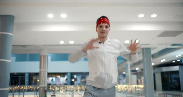 Man Confidently Making Hiphop Movements Dancing in Business Center