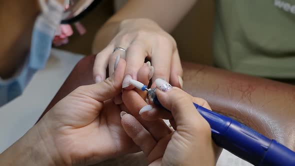 the Manicurist Polishes the Nail By Removing the Old Gel and Shaping