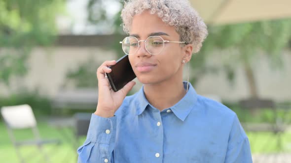 Portrait of Young African Woman Talking on Phone
