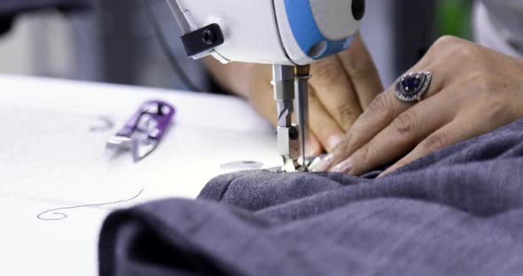 Tailor working on electric sewing machine