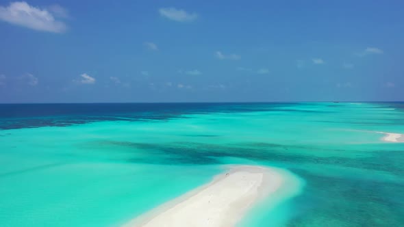 Aerial drone shot tourism of relaxing seashore beach adventure by blue green water with bright sand 