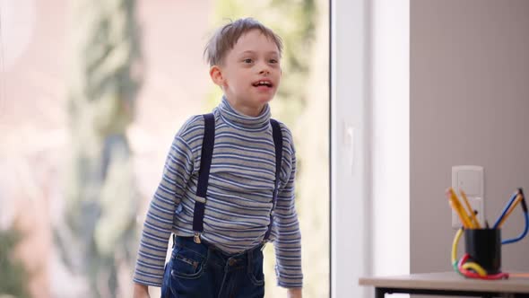 Hyperactive Autistic Boy Jumping Gesturing Indoors Laughing Having Fun