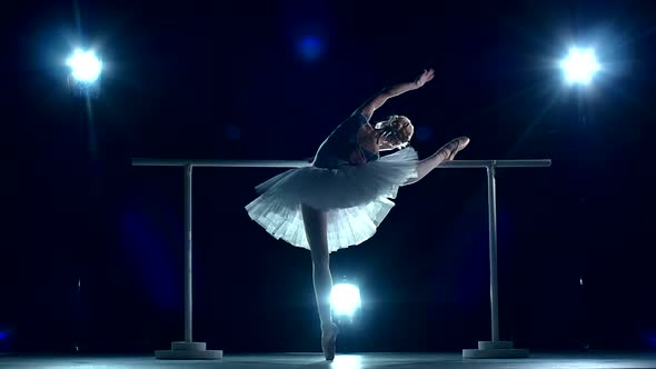 Young Dancer Doing a Workout in the Classroom Near Barre. Slow Motion