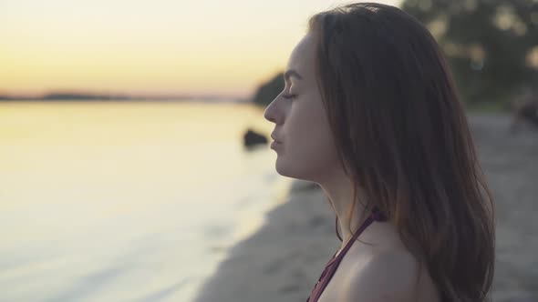 Close-up Face of Concentrated Young Beautiful Woman Breathing in and Out Raising Hands. Portrait of