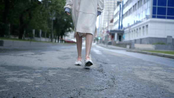 Video From Below the Foot of Girl Who Walks Around the City in White Sneakers