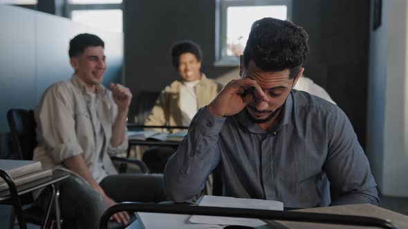 Frustrated Oppressed Indian Student Sitting in Class Lonely Young Guy Suffers From Abuse Bullying By