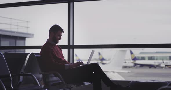 In the Airport Chairs Businessman Typing on His