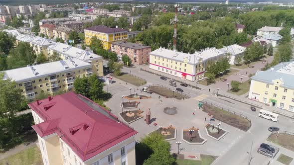 Aerial view of Square with flower beds and a small fountain and alley 12