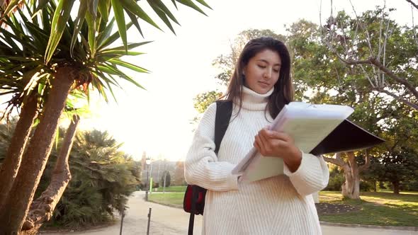 Slow Motion Cheerful Female Tourist in Eyeglasses Installing Navigator on Modern Telephone Device