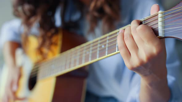 Woman Hands Playing Acoustic Guitar. Teenage Girl Creating Song with Guitar