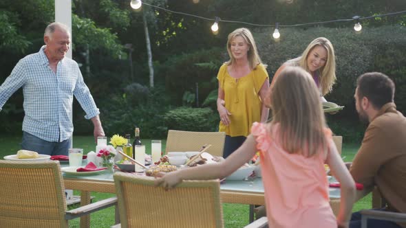 Three generation family enjoying lunch outdoors