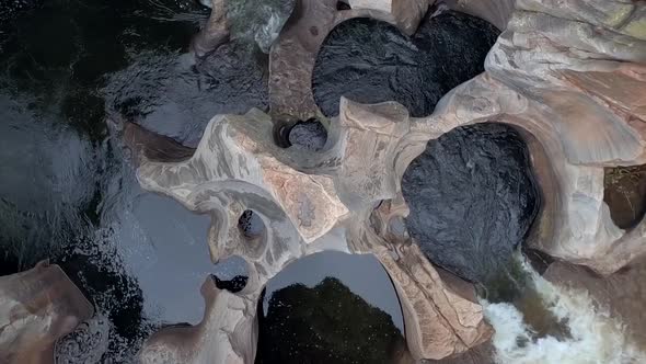 Aerial HD drone footage of a bird's-eye view of the Blyde River flowing through the base of Bourke's