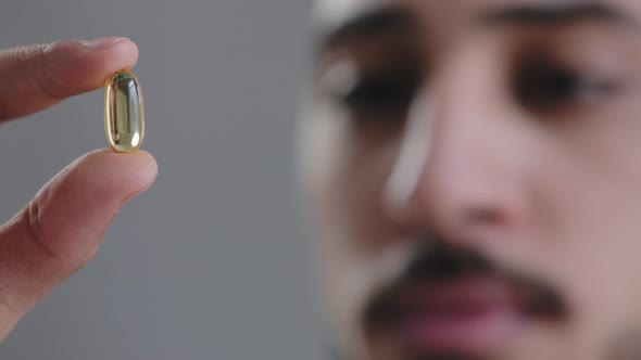 Macro Shot Clear Capsule in Male Doctor Cardiologist Hand Sick Man Showing at Camera Transparent