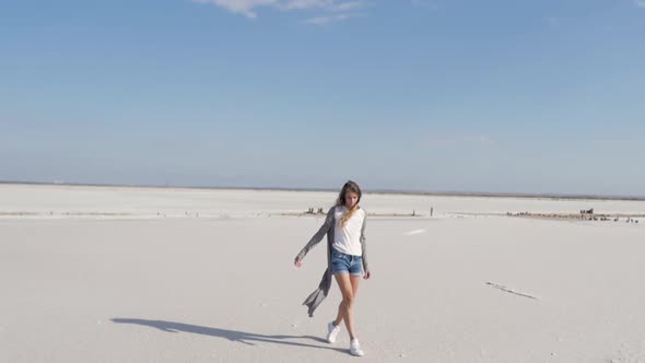 Happy Woman on White Salt Lake on Sunny Summer Day