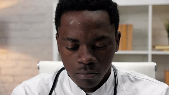 Close Up Face African American Man Doctor Working Uses Computer in Clinic Office