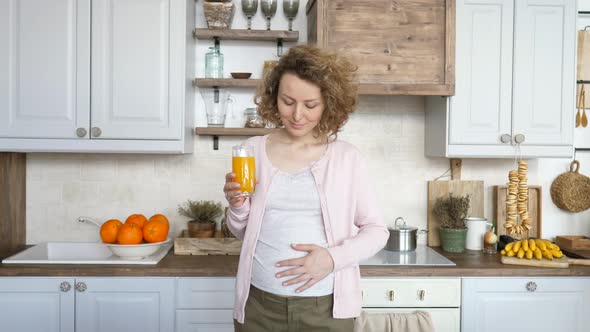 Pregnancy And Healthy Diet Concept. Pregnant Woman With Glass Of Fresh Orange Juice.