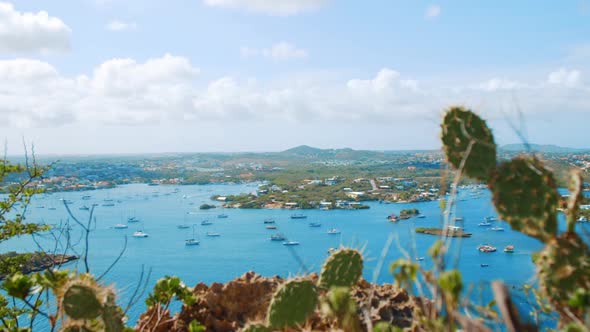 Boats in Spanish Waters bay, seen from a high viewpoint with cactus in Caribbean