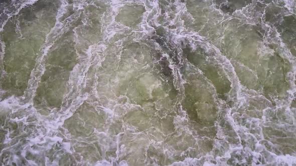 Top view of a large stream of water. Splashes of water. Hydroelectric power plant. Cleaning station