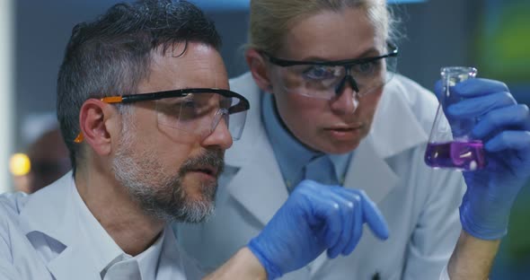 Scientists Examining Various Liquids