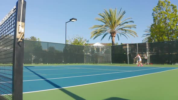 Slow-motion Commercial Footage of a Tennis Match. Athlete Practices Tennis Sport