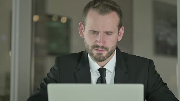 Close Up of Tired Businessman Having Neck Pain in Office at Night