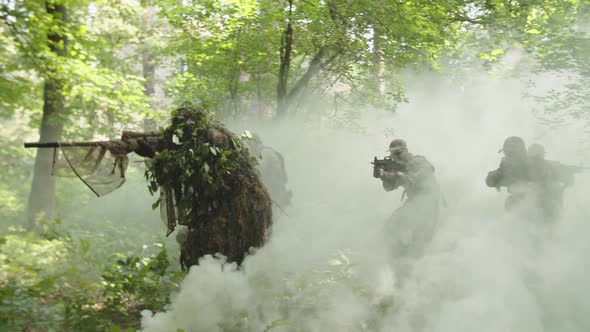 Military Group Moving Forward Forest Area Under Cover Cloud of Smoke