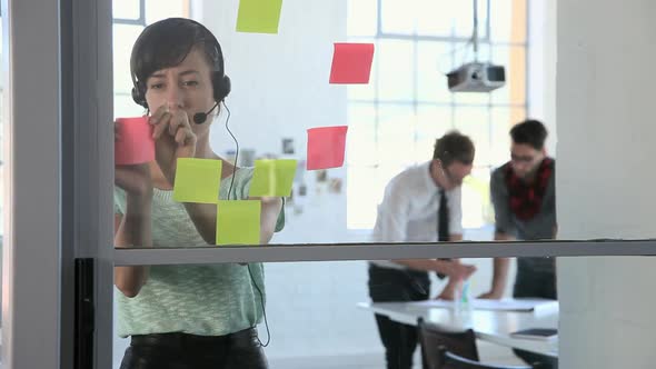 Young female fashion designer with headset