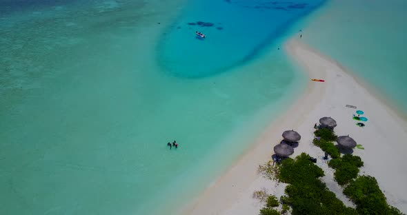 Daytime flying clean view of a white sand paradise beach and blue ocean background in colourful 4K