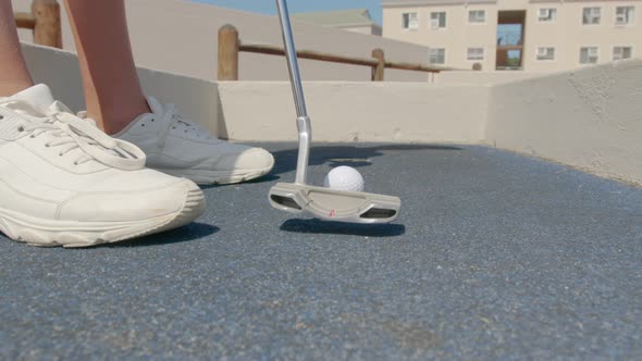 Close Up of the Golf Stick Hitting a Golf Ball  Mini Golf