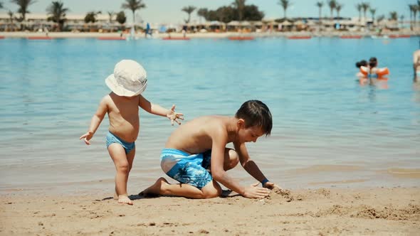 Adorable Cute Children Spending Summer Time at Beautiful Coastline.