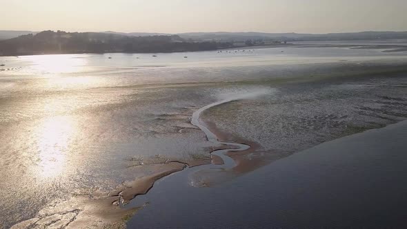 Breathtaking view from the sky of coastal town in South England. Water and sand formations are visib