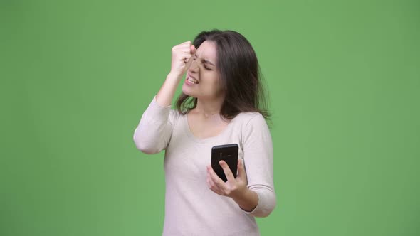 Young Beautiful Woman Using Phone and Getting Good News