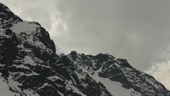 Time lapse of clouds moving over rugged mountains