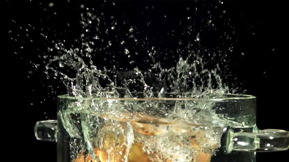 Potatoes Fall Into a Pot of Water with Splashes