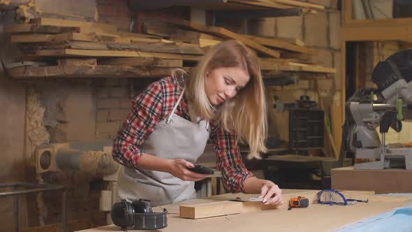 Young Carpenter Woman Use Mobile Phone