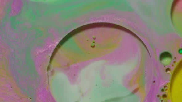 Ink Bubbles Mixed with Liquid Substance of Oil Milk Soap Bright Acrylic Paint on Colorful Surface