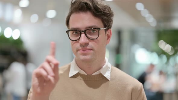 Young Male Designer Showing No Sign By Finger Gesture
