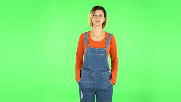 Woman Standing, Spreads Out in a Smile and Looks at the Camera. Green Screen