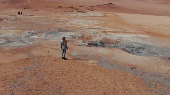 Woman standing through deserted valley