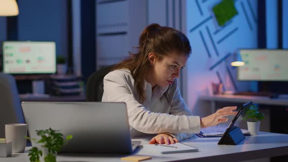 Manager Woman Using Laptop and Tablet in Same Time Working Overtime