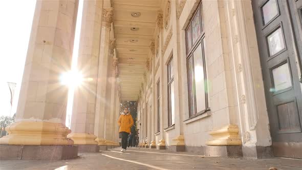 The Girl Walks Past Beautiful Historical Columns