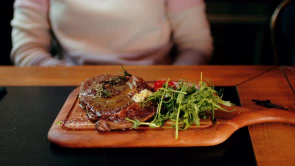 Succulent Steak with Vegetables on Wooden Board