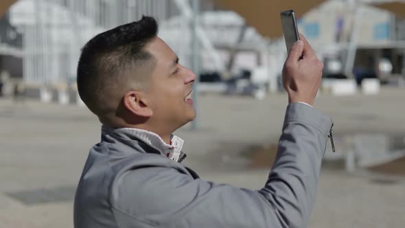 Handsome Young Man Recording Video with Smartphone