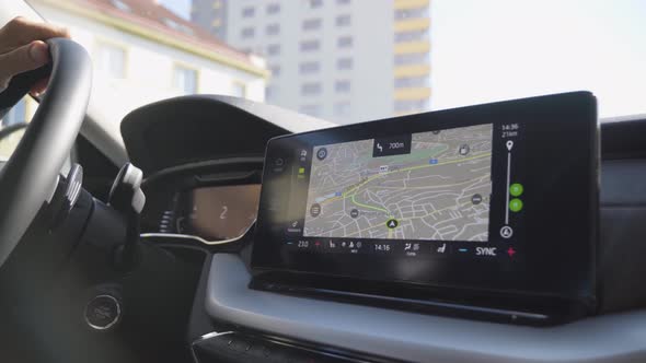 A Map and GPS on the Touchscreen System on the Dashboard As the Car Starts Driving  Closeup