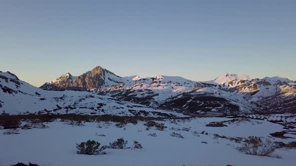 Aerial approach of snowy mountains in winter time