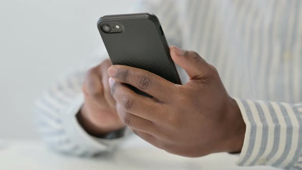 Close Up of African Man Using Smartphone Mobile