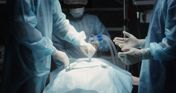 A Team of Surgeons Perform an Operation in a Bright Operating Room