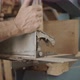 Carpenter slides in a metal plate on a saw - VideoHive Item for Sale