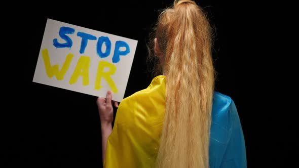 Back View Woman in Blue and Yellow Ukrainian Flag Showing Stop War Banner