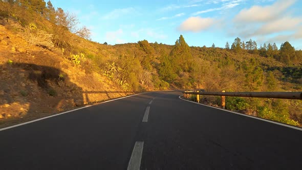 Long asphalt road ground view with sunset light and travel concept - mountain and sky